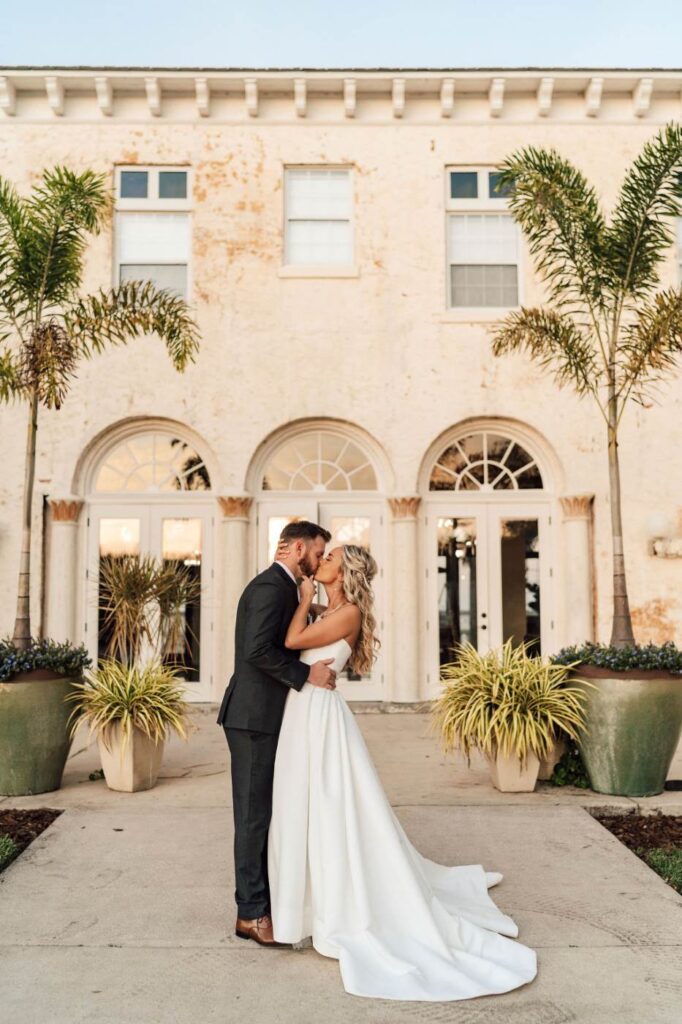 Couple kisses outside the Bella Cosa Central Florida Wedding Venue
