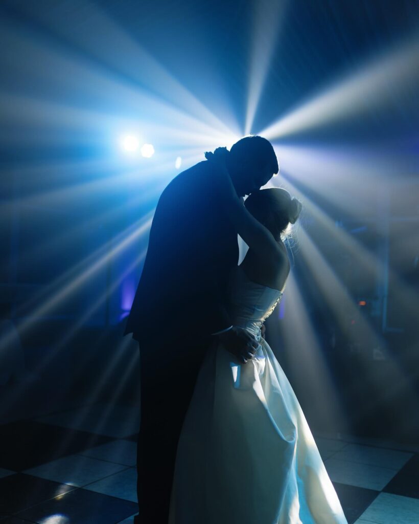 Newlyweds embrace during their first dance at Adam's Estate in Central Florida