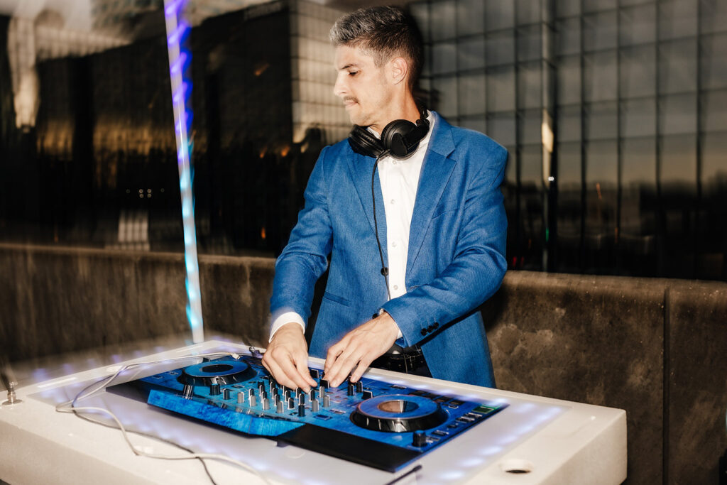 Tampa DJ in a blue suit on top of a Tampa high rise building