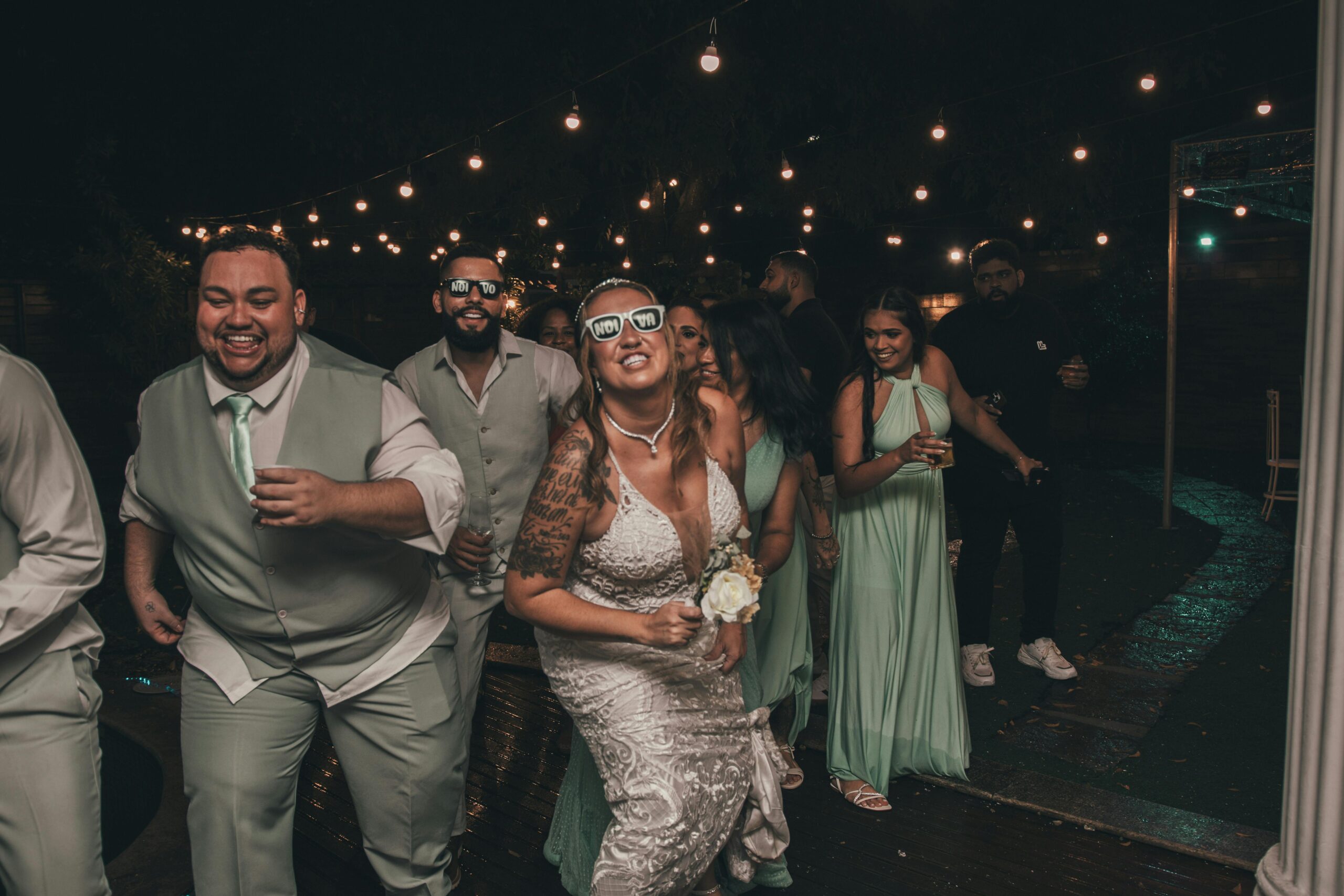 Bride dances with groomsmen on the dance floor